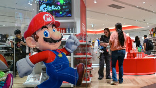 Gold nears $5,000, silver shines as stocks slip on turbulent week